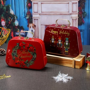 Christmas themed tin gift boxes with metal handles and locks on a wooden base
