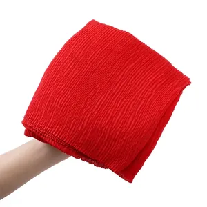 Detail showing the elastic pleated texture of a red cotton linen blend scarf wrap