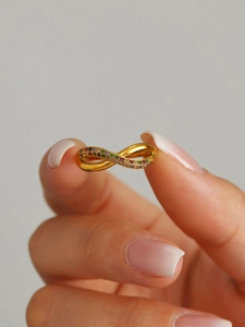 Macro shot of 18K gold plated twisted ring with colorful zircon rainbow stones