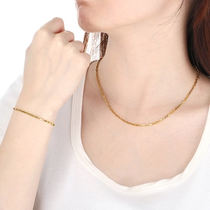 Elegant gold-tone stainless steel box chain necklace and bracelet set worn by a model