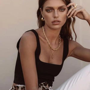 Close-up of layered gold twist necklaces and matching jewelry set on a model