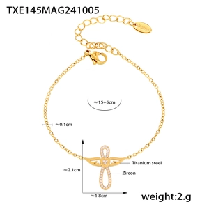 Détail du bracelet en acier titane doré avec pendentif croix aile d'ange en zircon