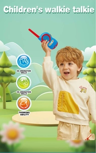 Child playing with a blue and red walkie-talkie in a cartoon forest setting