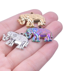 Detailed close-up of elephant pendants in gold, silver and rainbow plated stainless steel