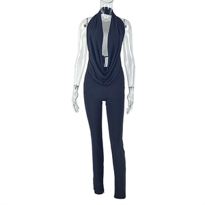 Close-up of black halter neck jumpsuit featuring a deep V-neckline and open back design