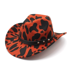 Classic western cowboy hat featuring orange and black cow print with studded leather band