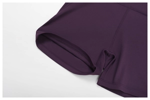 Detailed close-up of dark purple yoga shorts featuring flat-lock seams and double-layer hem