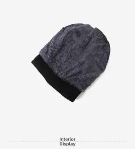 Detailed close-up of thick grey plush faux fur lining and black ribbed knit cuff of beanie