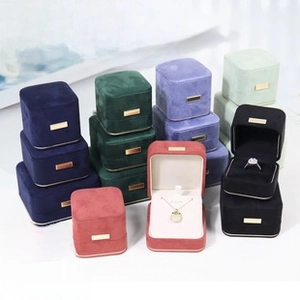 Group display of colorful velvet jewelry boxes with elegant gold trim and white lining