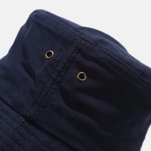 Navy blue cotton bucket hat with textured fabric and metal ventilation eyelet details