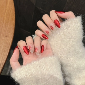 Handmade red cat-eye press-on nails with festive snowflake hand-painted patterns