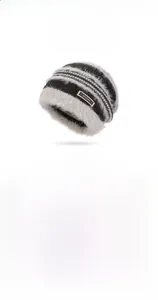 Detailed knit texture of a warm winter beanie featuring a stylish brand label