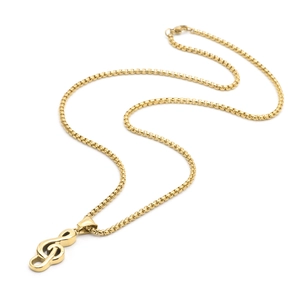 Detail of golden treble clef pendant on box chain necklace over a white background