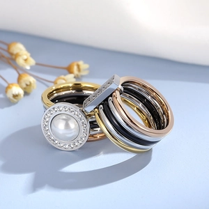 Multi-layer stacked ring set with mixed metal finishes, white pearl and zircon accents