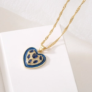 Classic 18K gold plated necklace with blue heart pendant on a white display stand