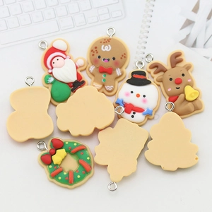 9-piece set of colorful Christmas resin charms including Santa, snowman, and gingerbread man