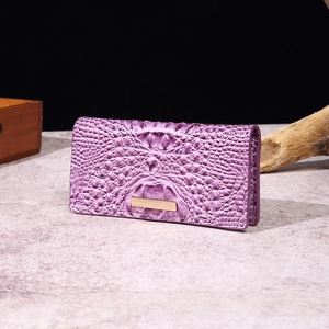 Close-up of purple faux crocodile leather wallet with elegant gold metal trim detail