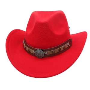 Detail of red western cowboy hat featuring leather band and vintage star metal buckle