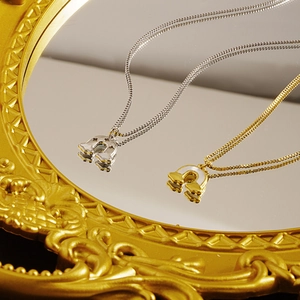 Minimalist cloud rainbow necklace in gold and silver finish on a luxury mirror reflection