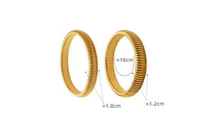 Detailed view of 1.0cm and 1.2cm wide gold plated ribbed elastic bangles on white background