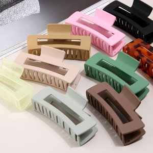Macro view of matte square claw clips set in various colors like pink and khaki