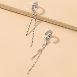 Detailed macro view of silver tassel earrings with micro-set zircon on the C-shaped cuff