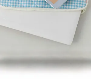 Close-up of blue checkered quilted laptop sleeve showing zip closure and device fit