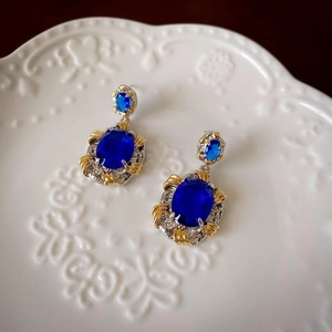Vue détaillée des boucles d'oreilles vintage en zircon bleu avec placage or et argent