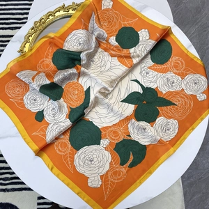 Vibrant orange camellia print satin square scarf with green accents and yellow border
