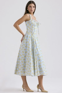 Detailed close-up of light blue floral print fabric and waist stitching on the maxi dress