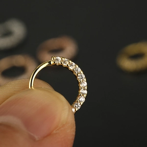 Macro shot of 20G gold plated nose ring with 10 hand-set cubic zirconia stones
