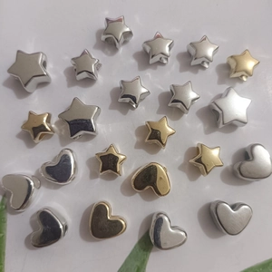 Close-up of gold and silver CCB star and heart beads for DIY jewelry making