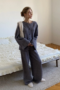 Close-up of deep grey knitted two-piece set featuring cardigan and wide-leg trousers