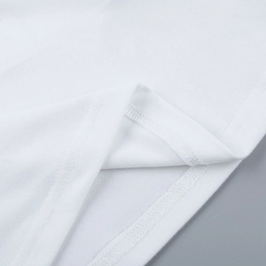Detailed macro shot of white knit cotton fabric and reinforced double-needle overlock seam