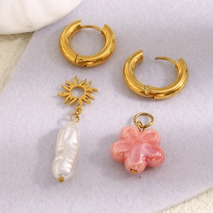 18K gold plated flower earrings set with baroque pearls and sun charms on soft felt