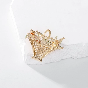 Elegant hollow flower basket brooch in gold tone with rhinestone accents and pin clasp