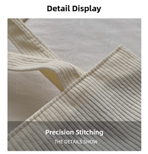 Detail view of precise stitching and corduroy texture on white shoulder bag