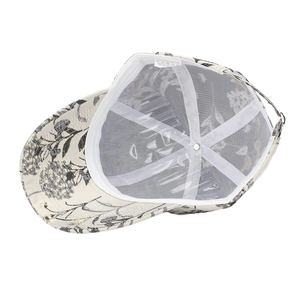 Detail view of ethnic floral baseball cap interior showing white mesh lining and sweatband