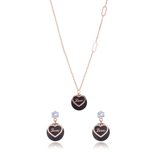 Rose gold heart jewelry set featuring black circular pendants and sparkling white stones