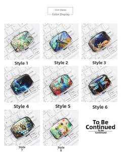 Various artistic patterns on portable square metal storage boxes with keyboard background