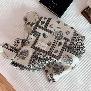 Detail of bohemian paisley print on cotton linen tote bag with artistic woven label