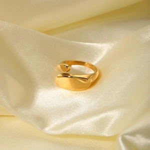 Irregular geometric 18k gold plated stainless steel open ring on champagne silk fabric