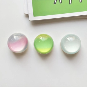 Detail view of round epoxy crystal cell phone grips with pearlescent gradient finish