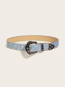Detail of light blue denim belt featuring silver carved buckle and sequin eyelet accents