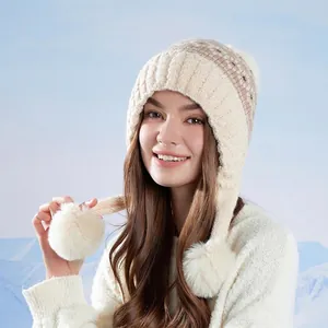 Beige Fair Isle knit trapper hat with pom-poms and fleece lining for winter warmth