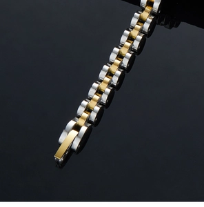 Detailed macro view of two-tone gold and silver stainless steel five-link watch band