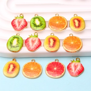 Macro shot of assorted fruit alloy charms with gold loops for DIY jewelry making