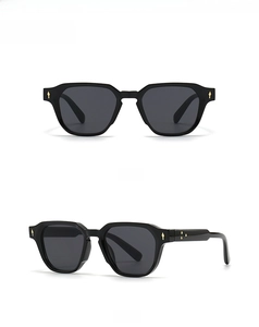 Close-up of black narrow frame sunglasses with golden floral detail and side view