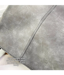 Detail of grey suede fabric with durable double stitching on a large tote bag