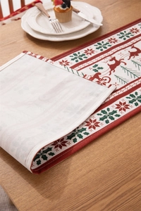 Detail of Christmas table runner with reindeer pattern and beige reverse fabric side
